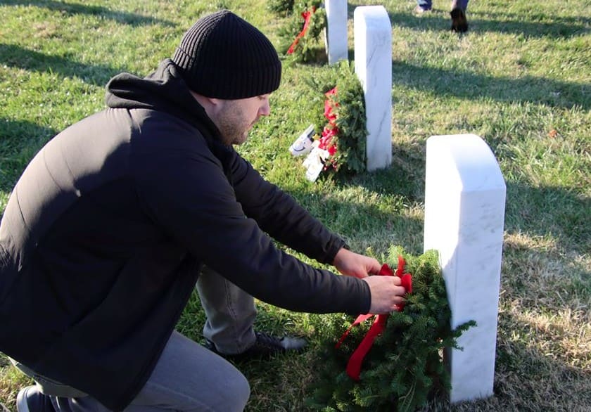 Volunteer placing a wreath at Arlington National Cemetery