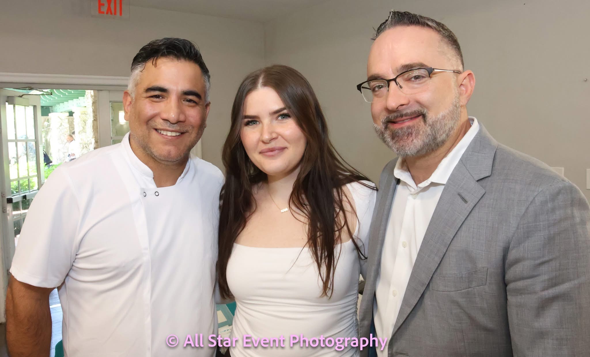 Three attendees smiling together at a PBA event