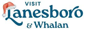 Holiday-themed ‘Visit Lanesboro & Whalan’ logo featuring the word ‘Lanesboro’ in blue script with a red-and-white Santa hat placed over the letter L.