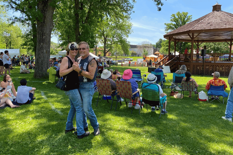 A couple dancing to live music in Sylvan Park in Lanesboro
