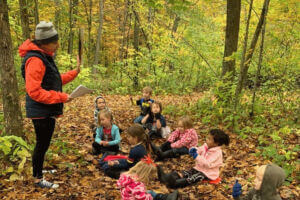 teacher and students outside at Eagle Bluff Nature Preschool