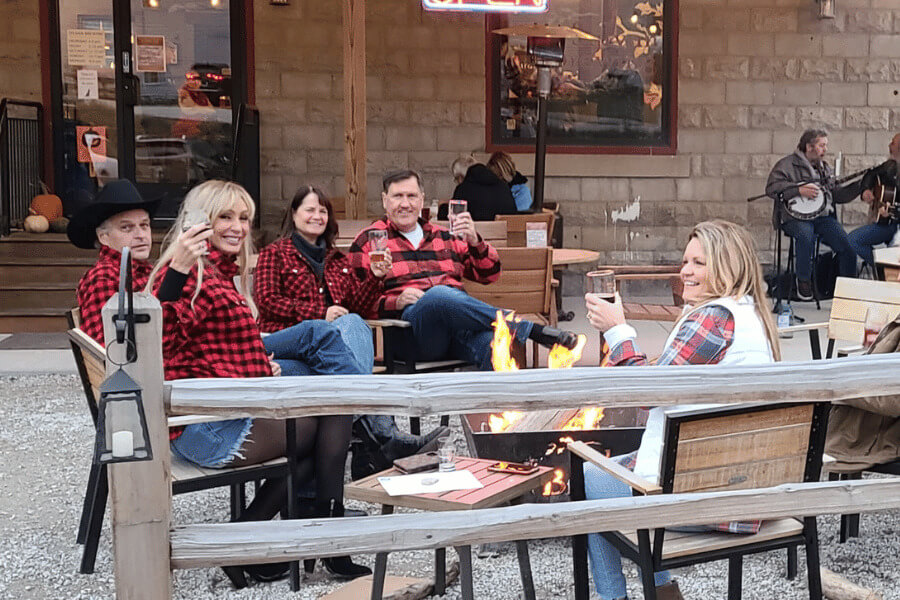 Folks enjoying a beer around a bonfire at Sylvan Brewing in Lanesboro.