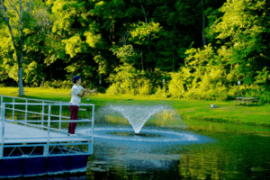 A child fishes off the dock at the pond in Sylvan Park in Lanesboro, MN