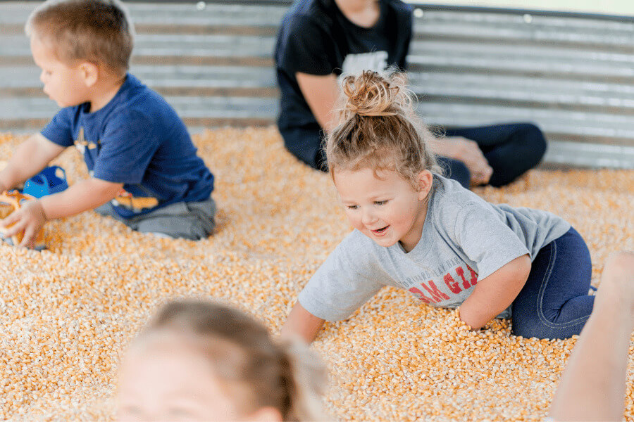 Young kids playing in corn at Big Springs Farms near Lanesboro, MN
