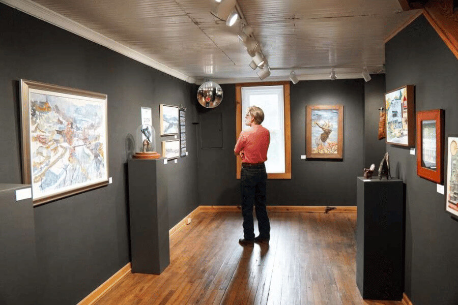 A patron admiring artwork at Lanesboro Arts Gallery