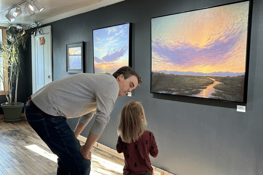 Parent and child admiring a painting at Lanesboro Arts.