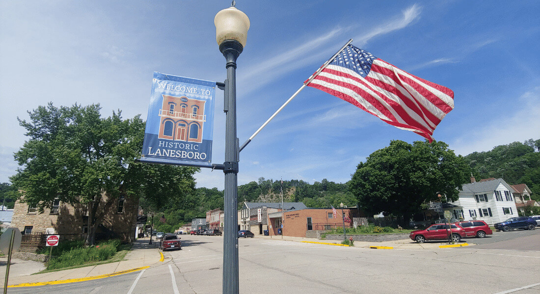 American flag next to a "Historic Lanesboro" sign