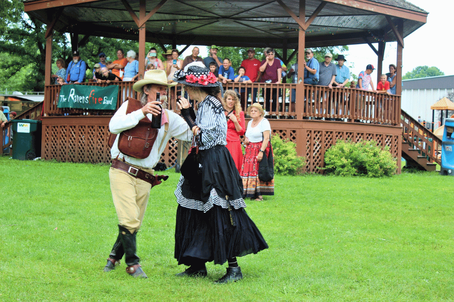 People in Old West attire dancing at Sylvan Park during Buffalo Bill Days.