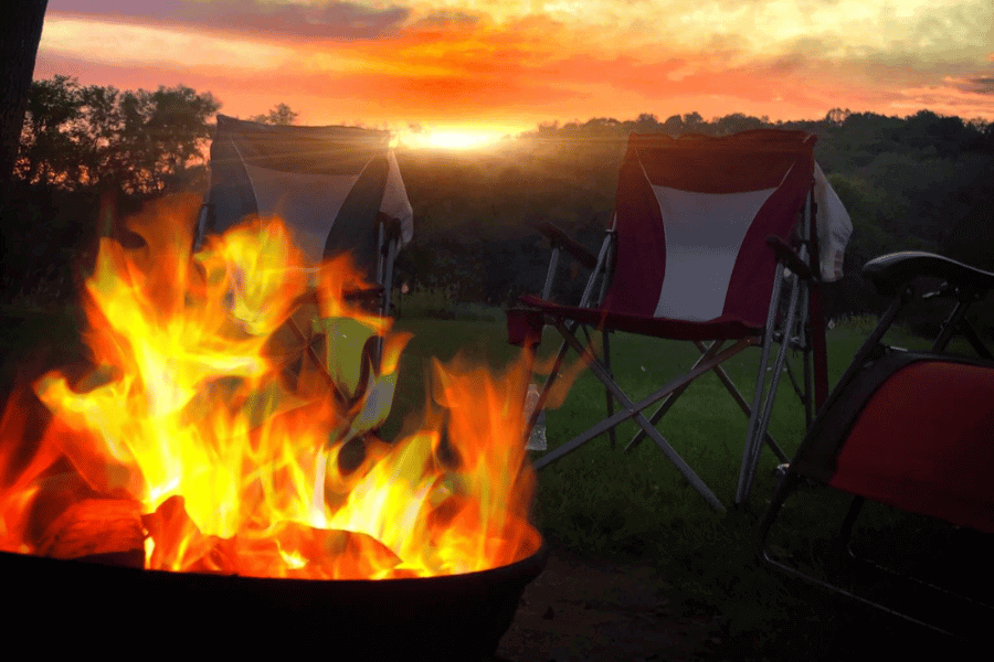 A bonfire during sunset at a campsite