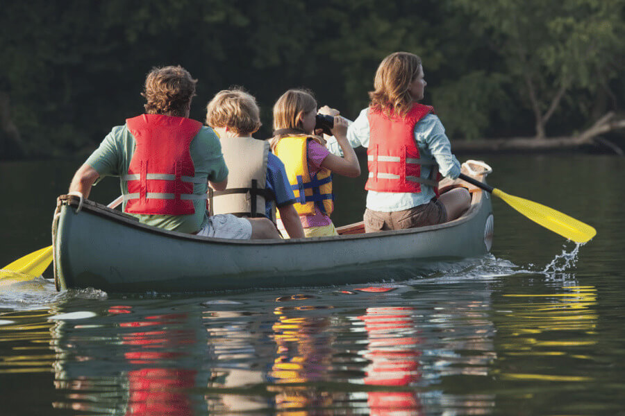 A family canoeing on the Root River near Lanesboro, MN