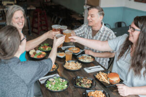 People enjoying a meal and beverages at Pedal Pusher's Cafe in Lanesboro