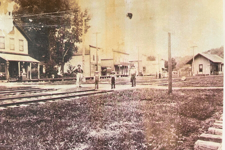 Whalan depot on the right of picture. Family on the tracks posing.