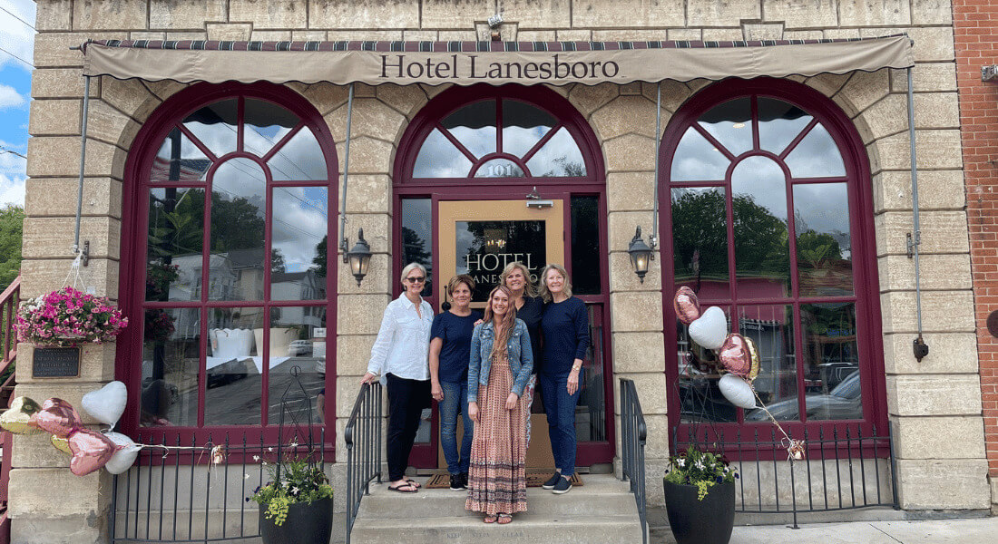 People standing on the front steps of Hotel Lanesboro