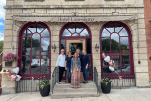 People standing on the front steps of Hotel Lanesboro