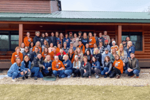 A group in front of a cabin at Cedar Valley Resort