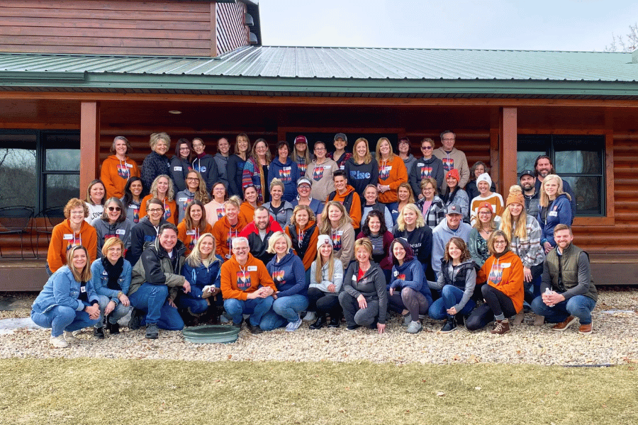 A group in front of a cabin at Cedar Valley Resort