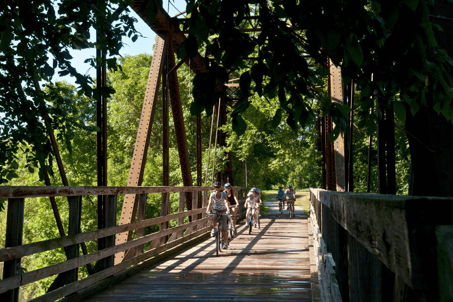 A family biking on the Root River State Trail