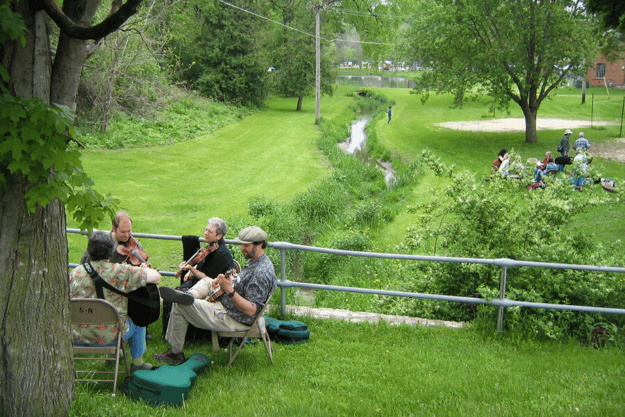People playing music together in green space in Lanesboro, MN