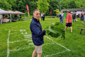 KTTC's Ted Schmidt throws a rhubarb stalk at the Rhubarb Festival in Lanesboro, MN