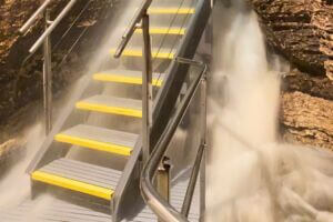 Stairway inside Niagara Cave surrounded by rushing floodwater after heavy rainfall