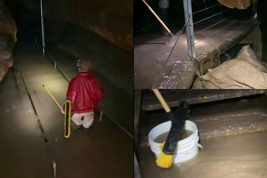 Niagara Cave staff cleaning floodwater and mud from cave walkways after heavy rainfall