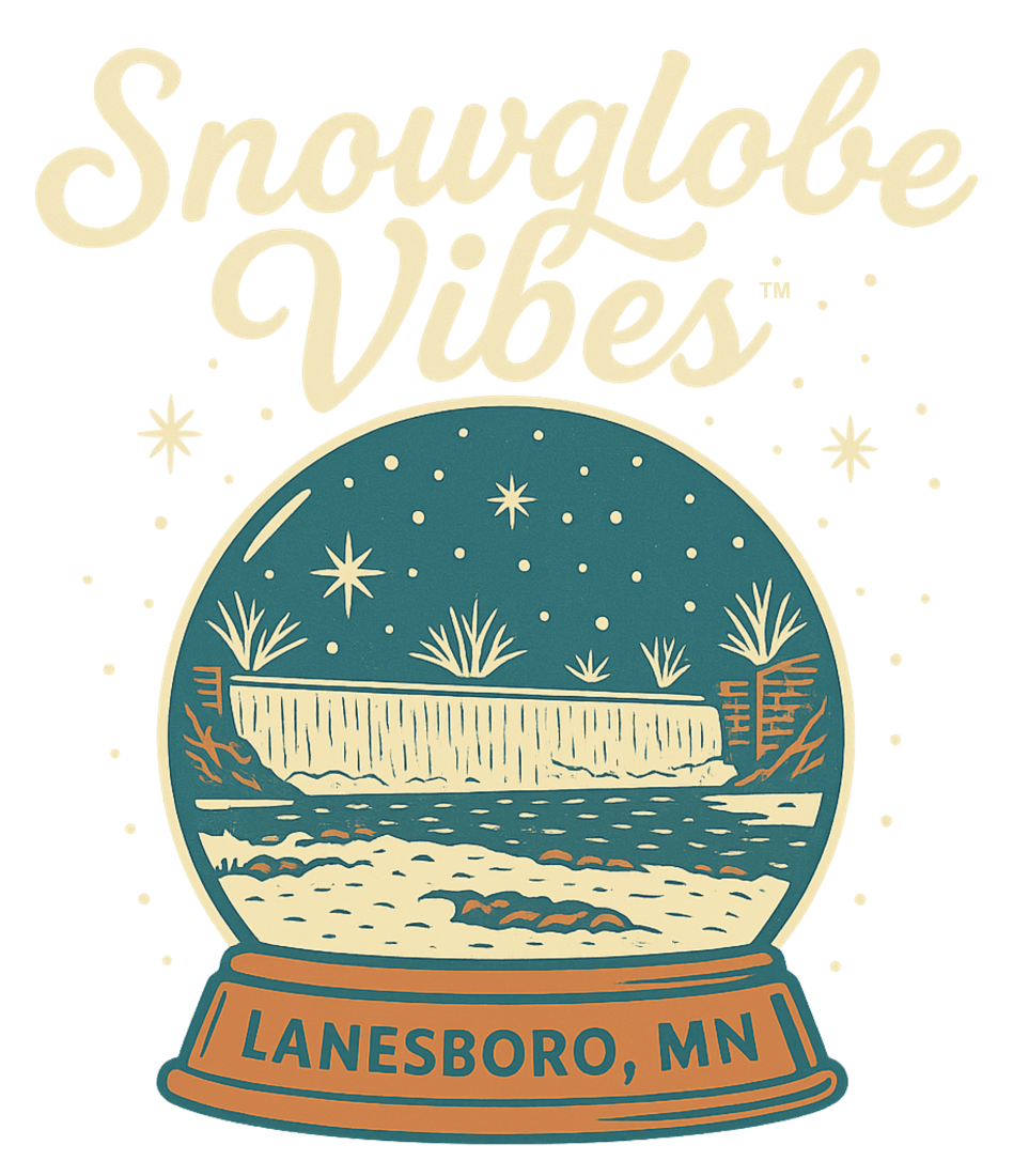 Illustrated “Snowglobe Vibes” logo featuring a vintage-style snow globe with the Lanesboro Dam inside, surrounded by stars and snowflakes, with the words “Lanesboro, MN” on the globe base.