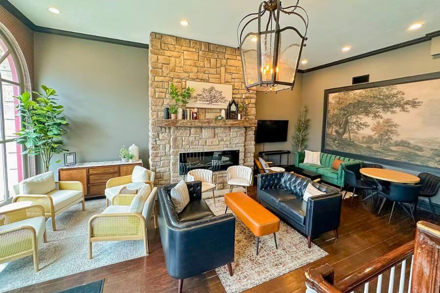 Renovated lobby at Hotel Lanesboro with stone fireplace, cozy seating, and modern furnishings in downtown Lanesboro, Minnesota.