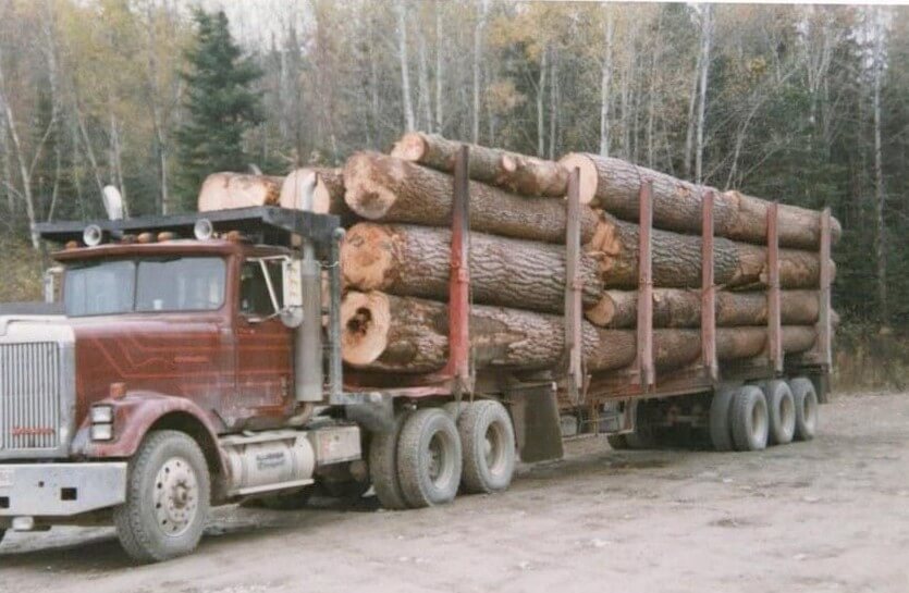 Syl-Ver Logging red truck loaded with timber in Allagash Maine Northern Maine logging operation