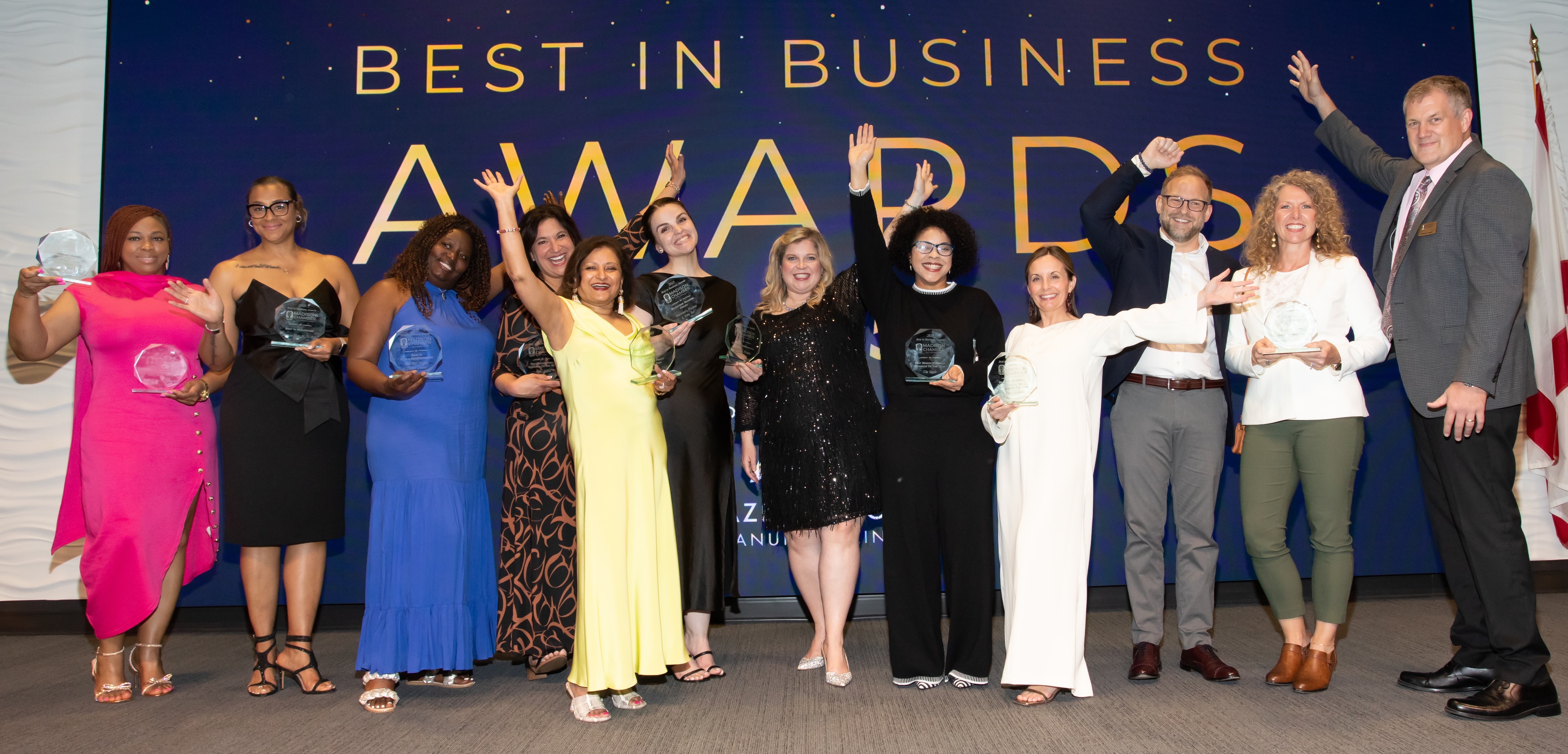winners of the 2025 Best in Business Awards lined up on stage with their awards