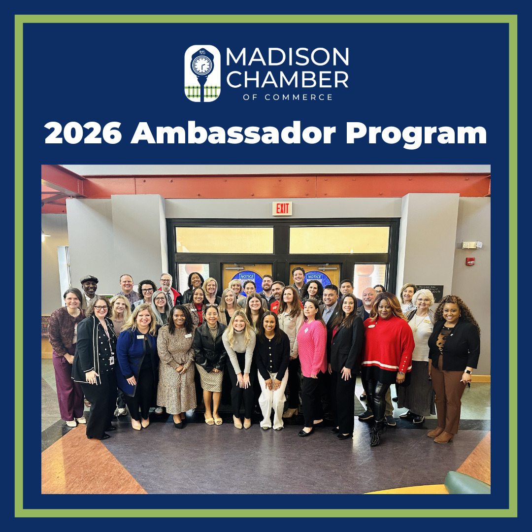 Graphic that says "2026 ambassador program" on a blue background, main picture shows a group of people smiling in the lobby of a training center