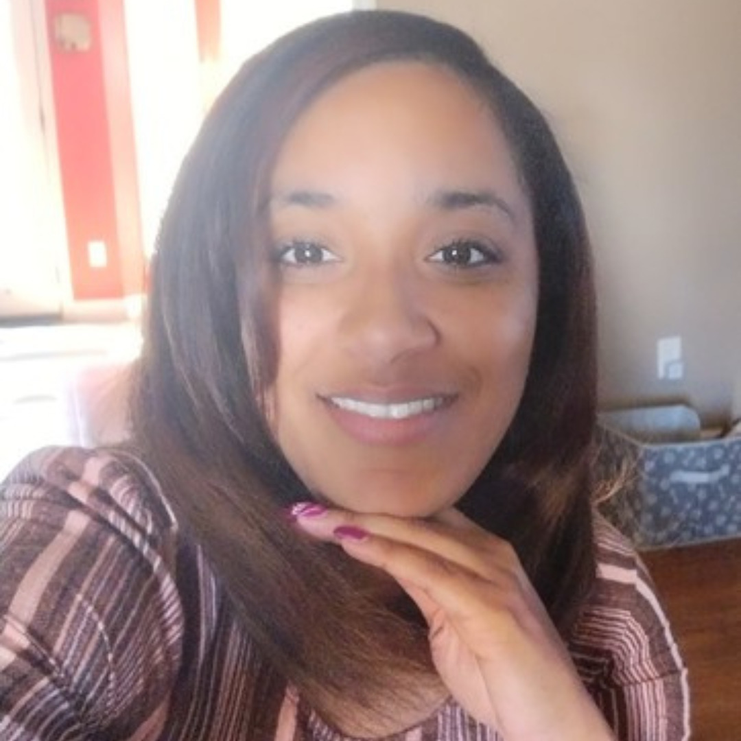 woman smiling with her hand on her chin