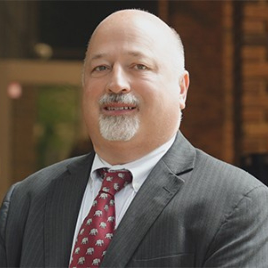 man smiling in gray suit