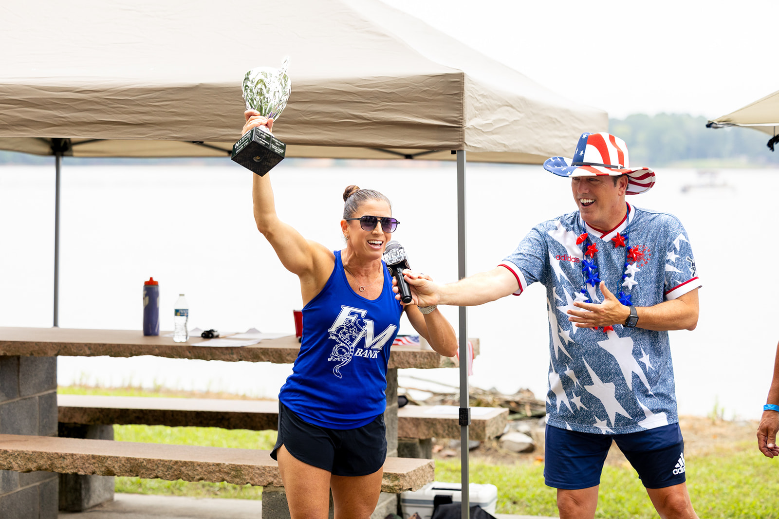 Dragon Boat Race 2026 Tonya Barber of F&M Banks hold Wellness Trophy alongside F&M Bank President & CEO, Steve Fisher.