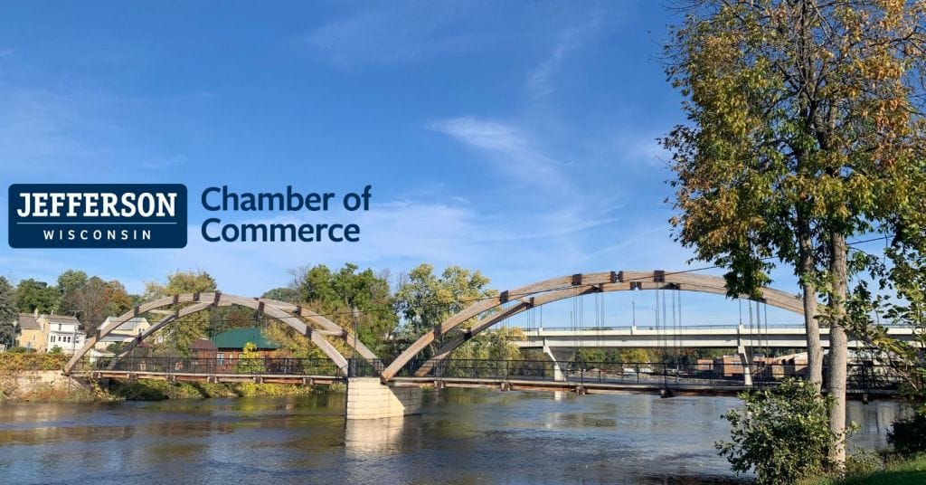 a photo of a bridge over a river with the Chamber of Commerce logo over it
