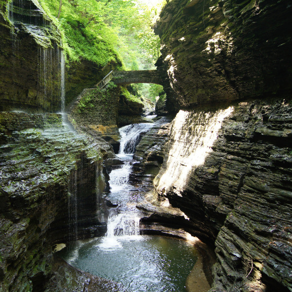 Rainbow Falls with a natural rock bridge and waterfall flowing underneath.