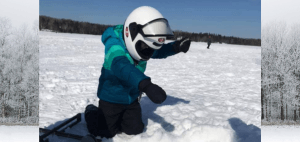 Young Child Ice Fishing with Helmet On