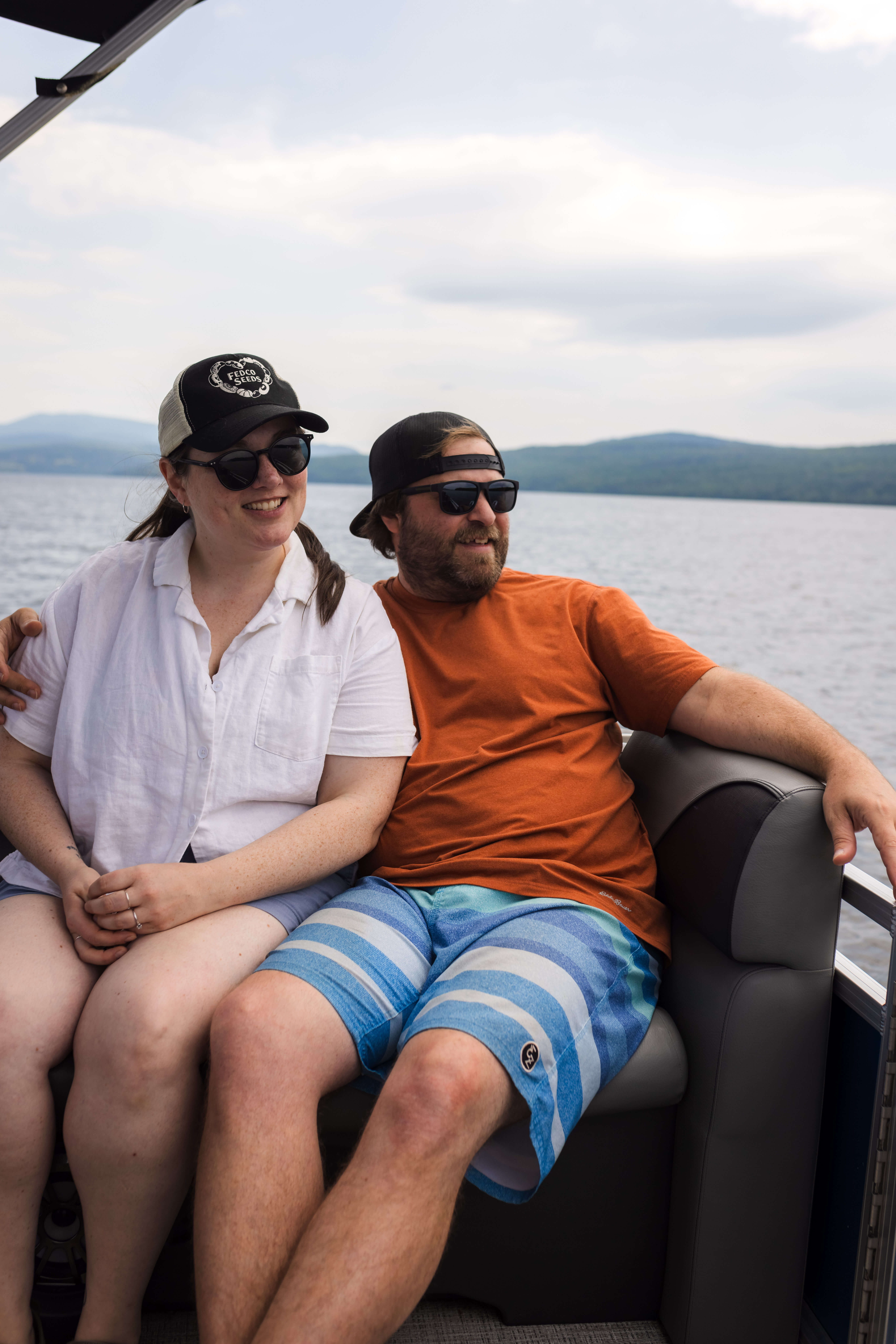 A couple enjoying a pontoon boat ride in Rangeley, Maine. 