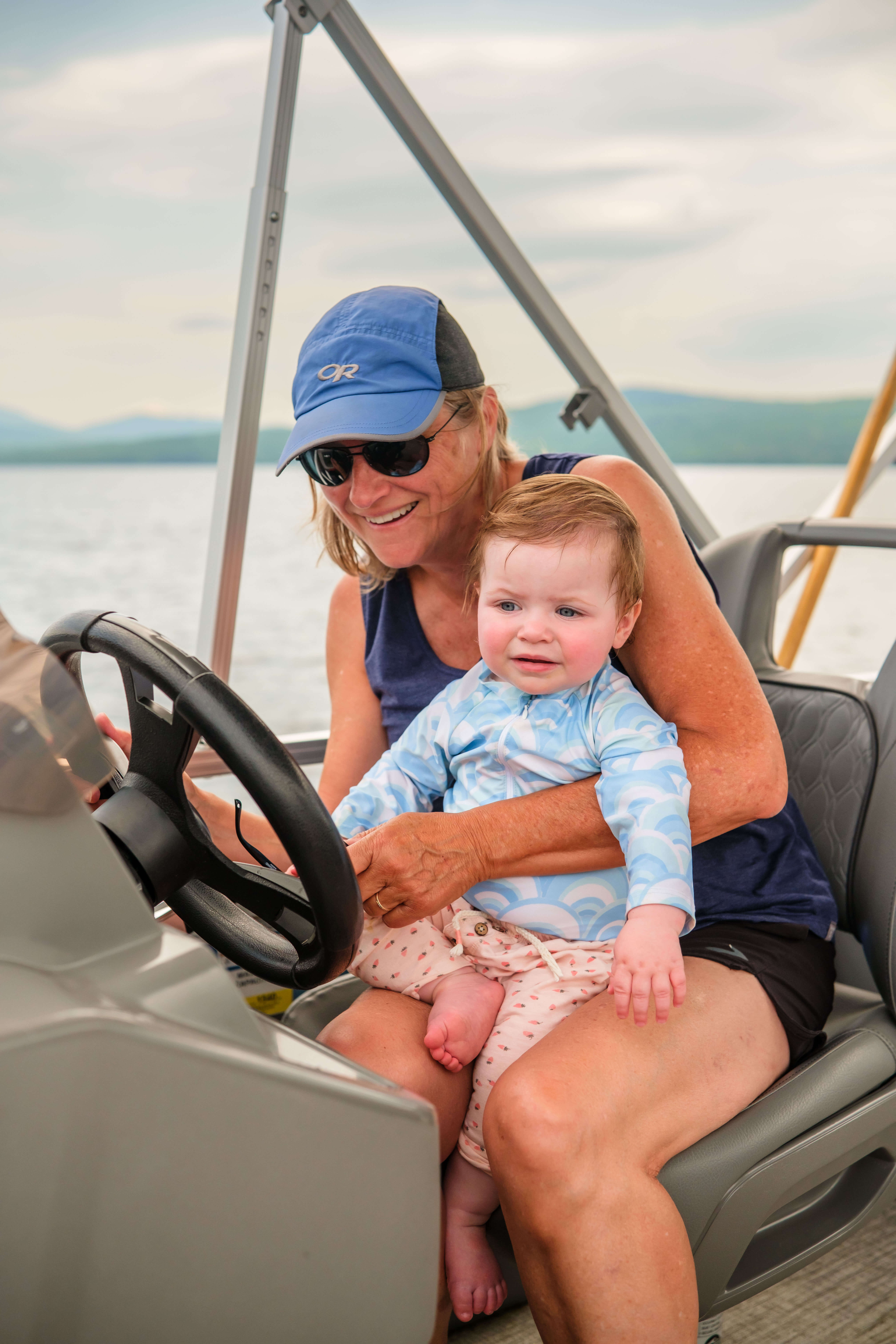 A family ejnoying a pontoon boat ride on Rangeley Lake. 