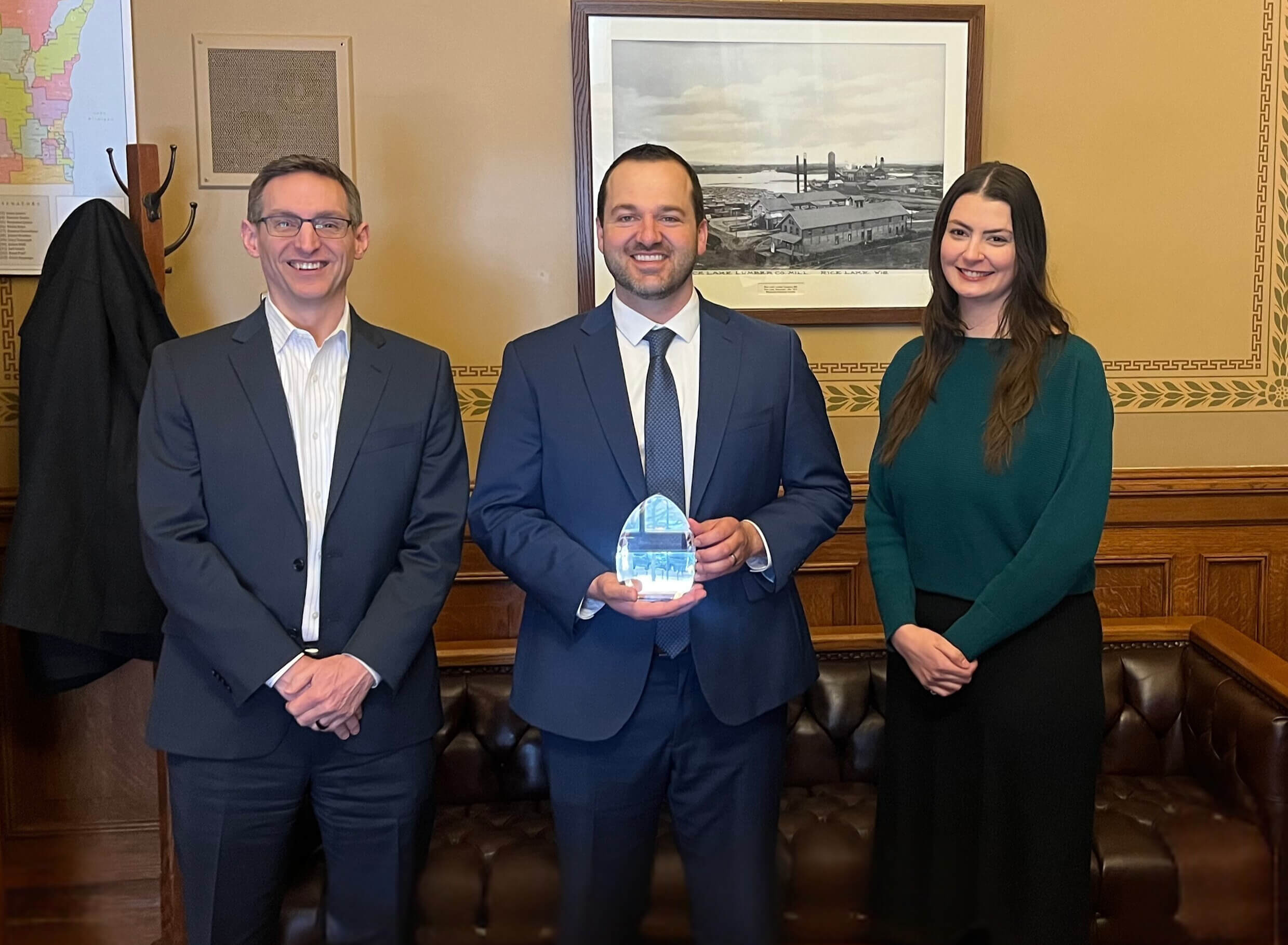Sen. Romaine Quinn receives his award at his Capitol office from PIA Executive Director Pete Hanson and Communications Director Natalie White.