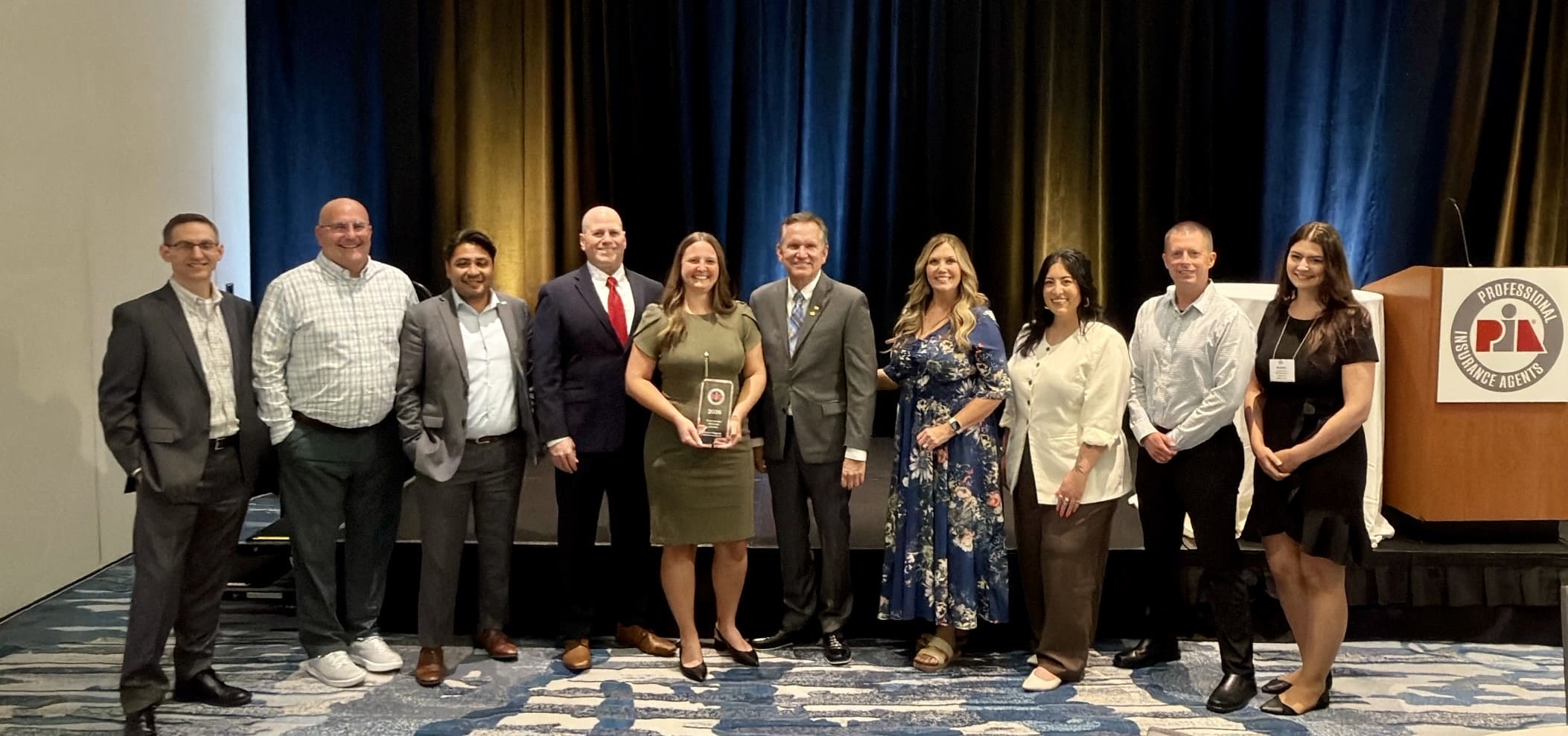 Alyssa pictured with her award alongside PIA National Executive Director Mike Skiados, PIA National Past President Mark Suhr and fellow representatives from the Professional Insurance Agents of Wisconsin. 
