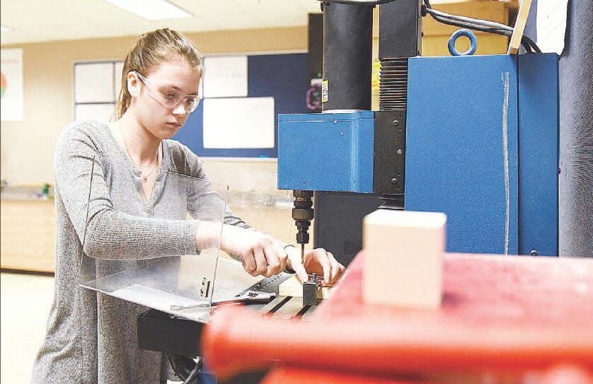 Samantha Cormier, a junior at Spaulding High School in Rochester, works in the engineering lab at the school’s technology center. She was setting up a computer-controlled milling machine.