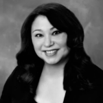 black and white photograph of female. Long dark hair. dark outfit