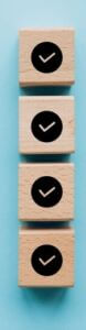 Checklist,Concept,,Check,Mark,On,Wooden,Blocks,,Blue,Background,With