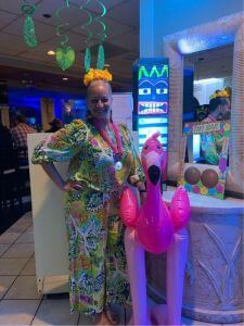woman standing next to inflatable flamingo