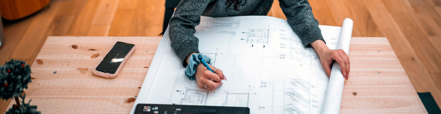 woman working with architectural floor plans