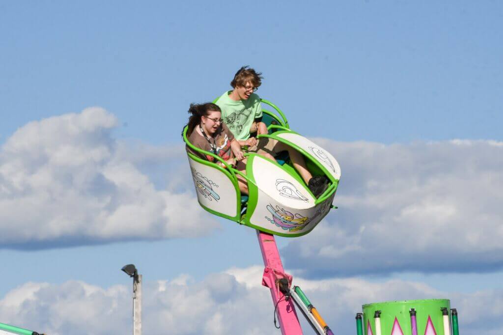 Teens on a ride at the county fair.