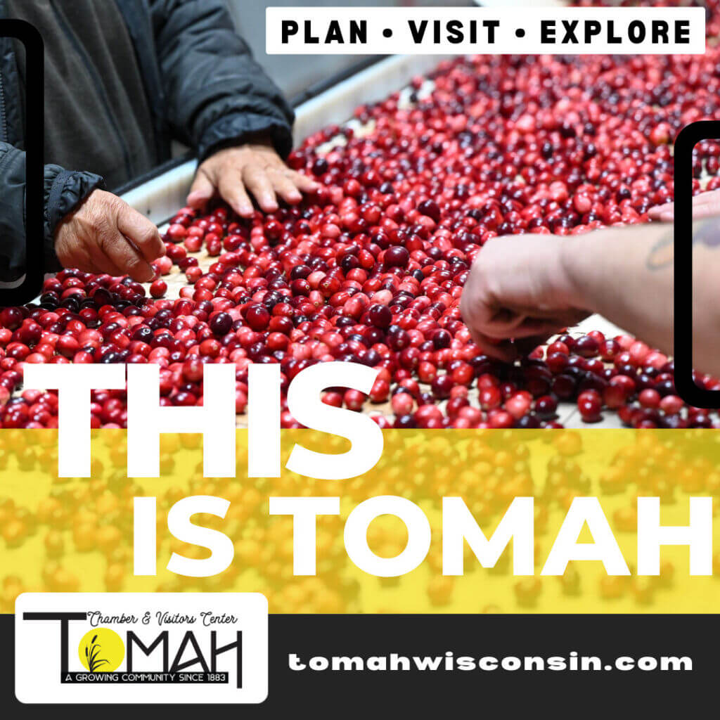 This is Tomah banner with hands sorting cranberries