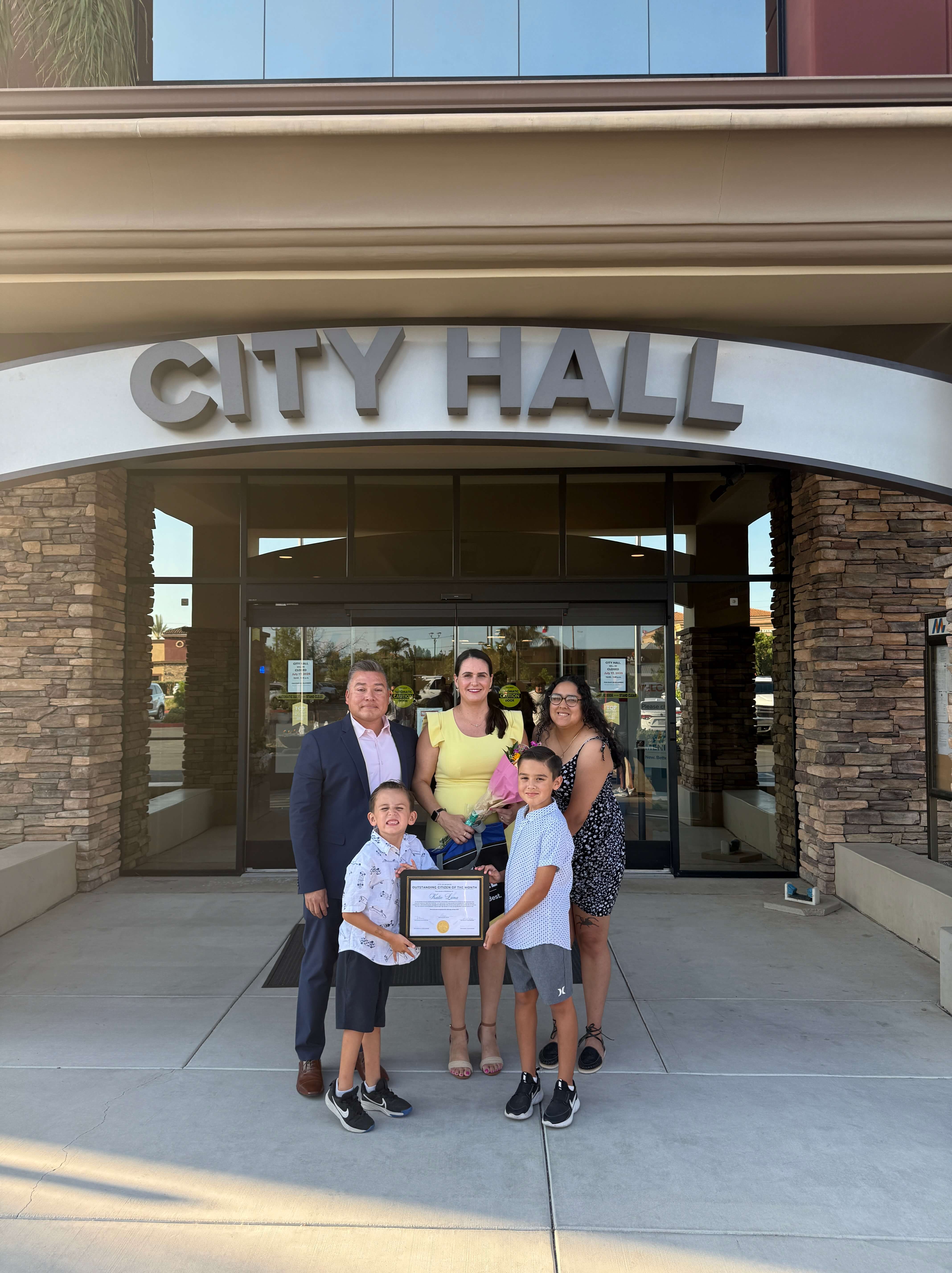 Katie Luna with her family outside of City Hall after receiving the Citizen of the Month Award