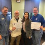 Photo of organizers presenting speaker with certificate of appreciation.