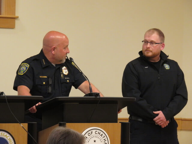 Chief Michael Anderson addresses the Select Board while Dispatcher Dana Grim stands beside him during the award presentation.